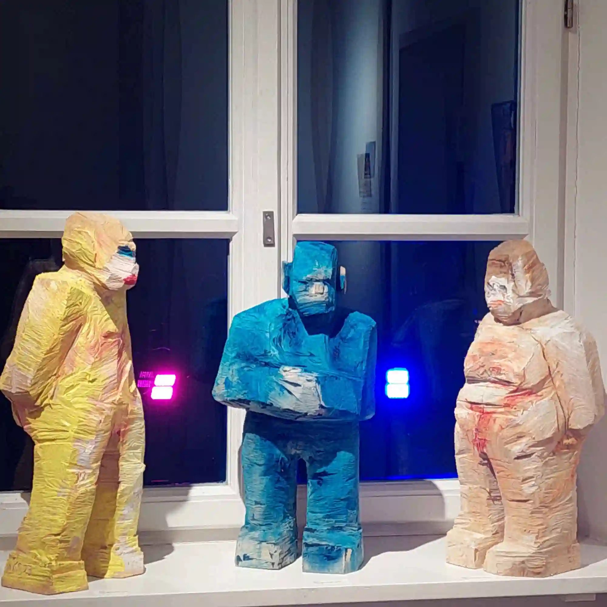 Drei kleine Holzfiguren aus der Serie der 'Engel' in der Ausstellung 'Kunst und Mehr 2025' im Pflegschloss in Schrobenhausen
